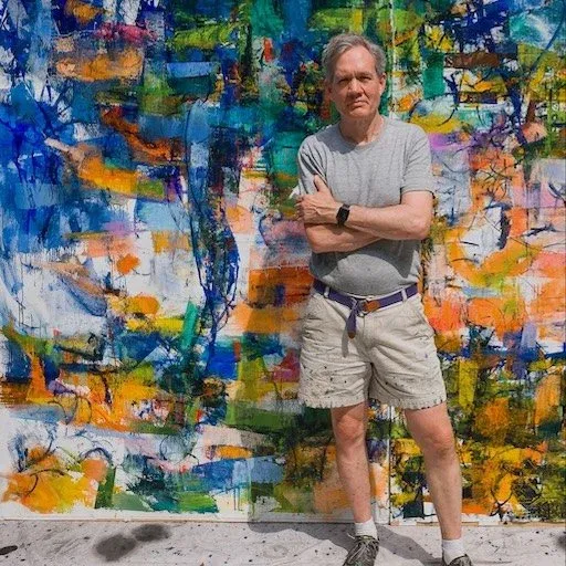 Christopher standing in front of colorful painting